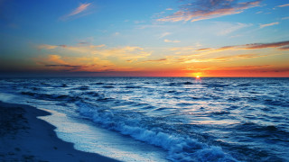 Sunset ocean waves boat sky - a boat in the distance free wallpaper