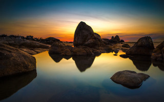 Sunset water rocks building sky - a sky in the background free wallpaper for desktop