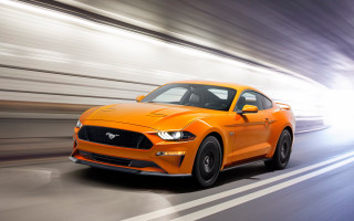 Bright orange mustang driving blurry - a street free wallpaper