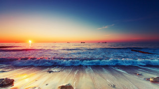 Sunset ocean waves boats beach - a sunset over the ocean free wallpaper