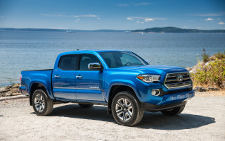Blue toyota truck beach ocean - a mountain in the background and a body of water free wallpaper