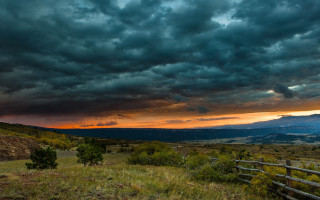 Field fence mountain clouds trees - stormy weather free wallpaper