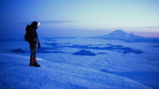 Man snowy mountain slope dusk - a backpack free wallpaper
