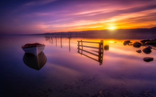 Boat sunset fence water mountain - rich moody colour free wallpaper