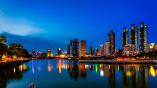 City skyline reflection boat night - a boat in the foreground free wallpaper