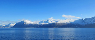 Mountain range snow water blue - a body of water below free wallpaper