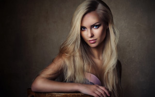 Serious blonde woman chair portrait - long blonde hair free wallpaper
