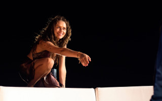 Woman sitting arabesque promotional portrait - a white couch free wallpaper