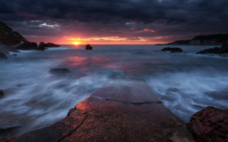 Sunset ocean rocks sky lighthouse - the foreground and a body of water free wallpaper for desktop