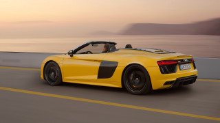Yellow sports car ocean sunset - a person in the driver seat free wallpaper