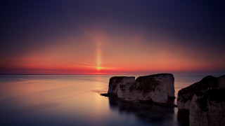 Sunset ocean rocks bright sun - a sunset over the ocean free wallpaper