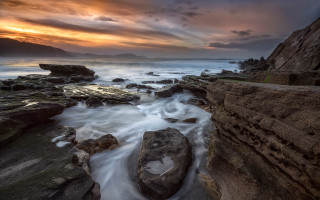 Rocky beach sunset clouds ocean - large free wallpaper for desktop