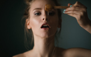 Woman brushing teeth wooden brush - a green background behind her free wallpaper