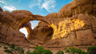 Large rock arch trees sky - a large rock formation free wallpaper