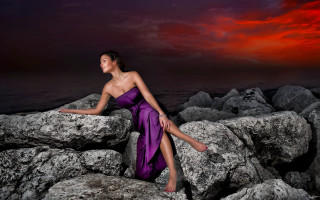 Purple dress sunset rocks ocean - a red sky in the background free wallpaper