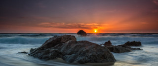Sunset ocean rocks wave shore - a rock in the foreground free wallpaper for desktop