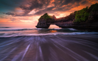 Ocean rock sunset waves person - a rock formation in the ocean free wallpaper