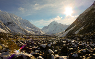 Mountain snowy landscape city light - a bright sun in the sky above free wallpaper
