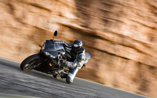 Man motorcycle curvy road rockwall - a rock wall in the background free wallpaper