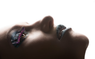 Woman feather face closed tilted - a feather free wallpaper