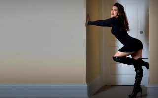 Woman black dress heels leaning - leaning against a wall free wallpaper