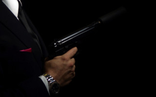 Man suit gun watch redtie - a man in a suit holding free wallpaper