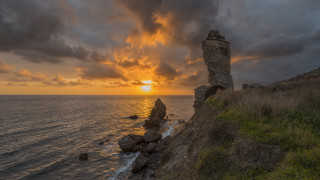 Sunset rocky cliff grassy hill - constantine andreou free wallpaper