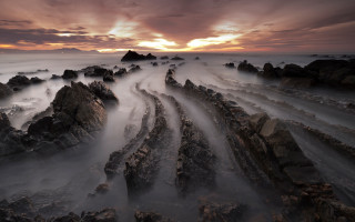 Longexposure rockybeach cloudyskies sunset horizon - a long exposure of a sunset over a rocky beach free wallpaper