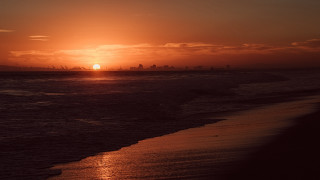 Sunset ocean city beach person - the beach in the foreground free wallpaper