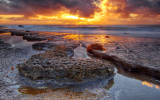 Sunset rocky beach water clouds 6 - a few rock free wallpaper