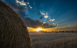 Hay bale sunset clouds cityscape - the sun setting behind free wallpaper for desktop