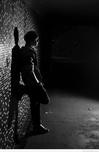 Man leaning brick wall dark - cam sykes free wallpaper for mobile