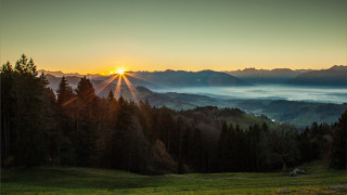 Sunset mountain range forest valley - a sunset over a mountain range free wallpaper