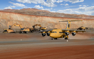 Yellow plane runway mountain rock - a large rock formation in the background free wallpaper