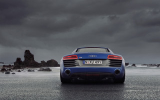 Blue car ocean wet road - the ocean under a cloudy sky free wallpaper