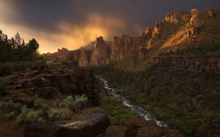 River forest mountains sunset sky - a lush green forest under a cloudy sky free wallpaper