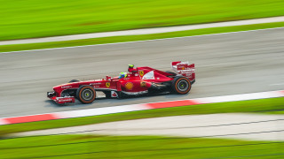Red race car motion blur 2 - a red race car free wallpaper