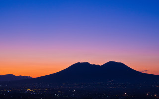 Mountain sunset city lights aurora - correggio free wallpaper