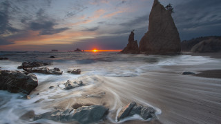 Sunset ocean rocks waves mountain 2 - a rock formation in the foreground free wallpaper