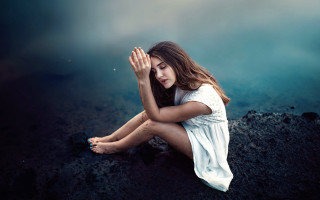 Woman sitting rock hands covered - a rock free wallpaper for desktop