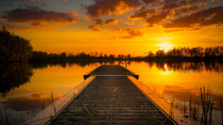 Dock lake sunset clouds buildings - a body of water below free wallpaper