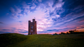 Tower greenfield cloudy sunset tiltshift - a lush green field under a cloudy sky free wallpaper
