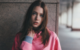 Woman blueeyes pinkshirt leaning wall - against a wall free wallpaper