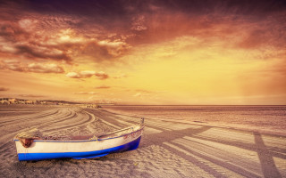 Boat beach sunset cloudy sky 4 - a sandy beach under a cloudy sky free wallpaper