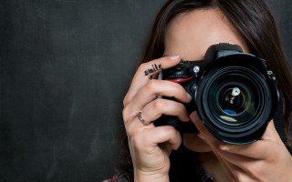Woman camera pose jewelry nail - a black background behind her free wallpaper for desktop
