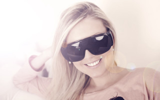 Woman pinkshirt sunglasses cellphone smile - sunglass free wallpaper