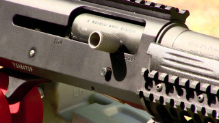 Gun red wheel black barrel - a close up of a gun free wallpaper