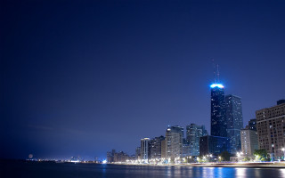 City skyline night water blue 2 - a large body of water in front free wallpaper