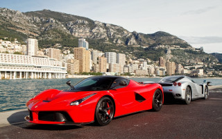 Red sports cars cityscape mountains - free cars wallpaper