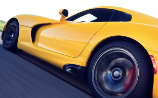 Yellow sports car driving blurry - a yellow sports car free wallpaper